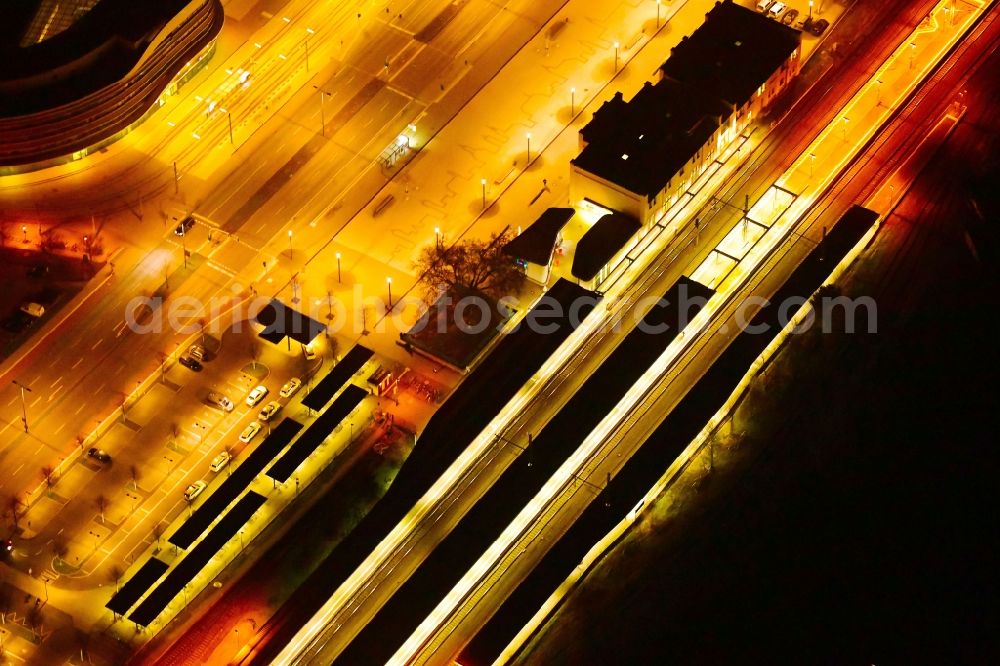 Brandenburg an der Havel at night from the bird perspective: Night lighting track progress and building of the main station of the railway in Brandenburg an der Havel in the state Brandenburg, Germany