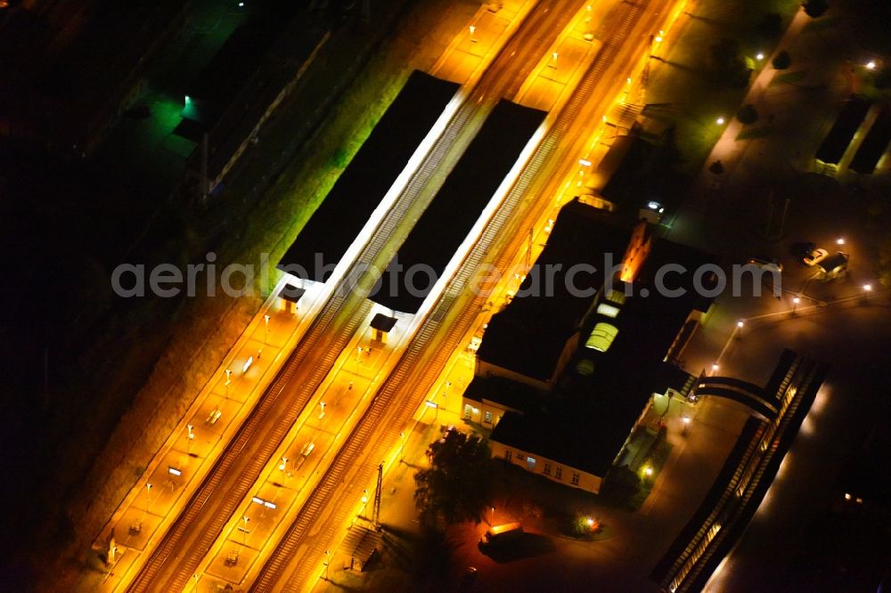 Güstrow at night from above - Night lighting Track progress and building of the main station of the railway in Guestrow in the state Mecklenburg - Western Pomerania, Germany