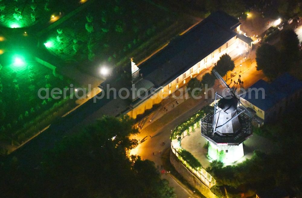 Potsdam at night from the bird perspective: Night lighting historic windmill on Maulbeerallee in Potsdam in the state Brandenburg, Germany