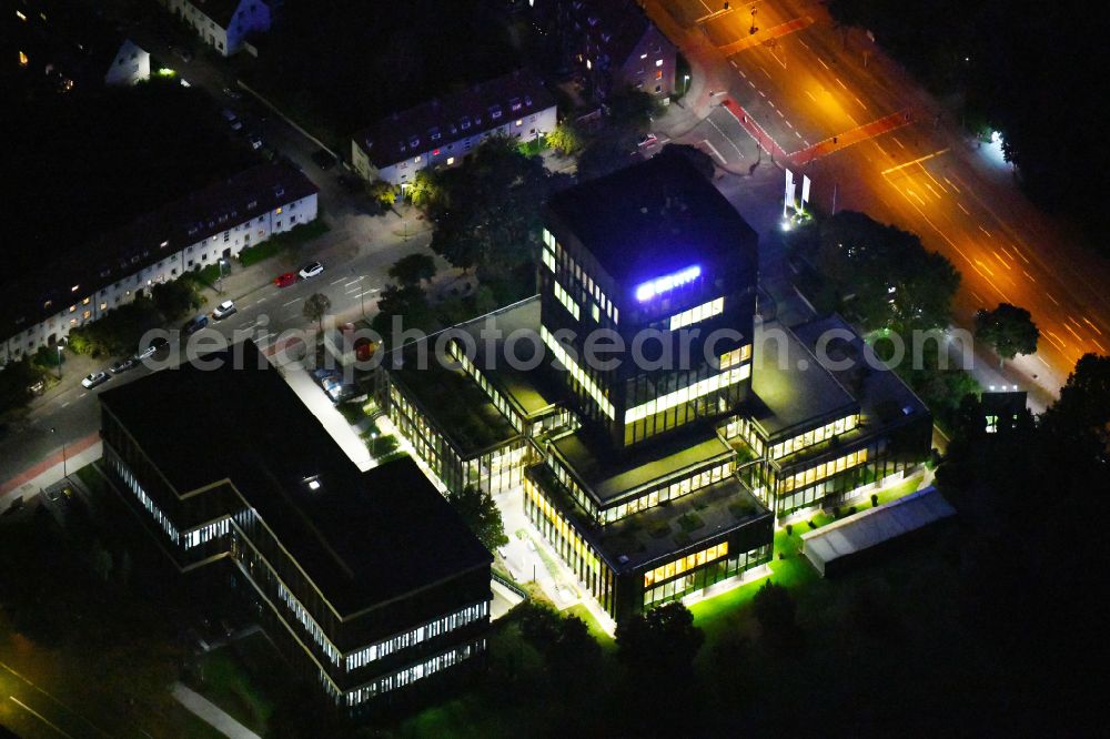 Münster at night from the bird perspective: Night lighting high-rise skyscraper building and bank administration of the financial services company on street Sentmaringer Weg in the district Geist in Muenster in the state North Rhine-Westphalia, Germany