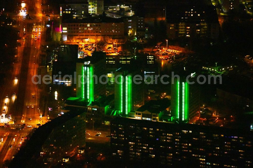 Aerial image at night Berlin - Night lighting High-rise building of the hotel complex Holiday Inn Berlin City East on Landsberger Allee in the district Lichtenberg in Berlin, Germany