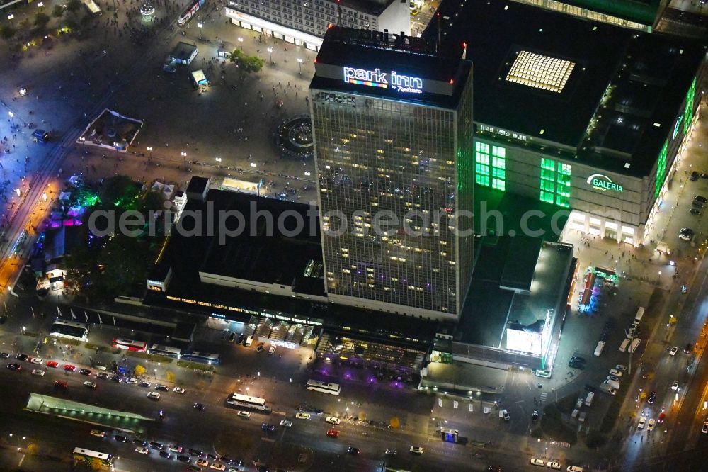 Aerial photograph at night Berlin - Night lighting High-rise building of the hotel complex Park Inn by Radisson Berlin Alexanderplatz in the district Mitte in Berlin, Germany