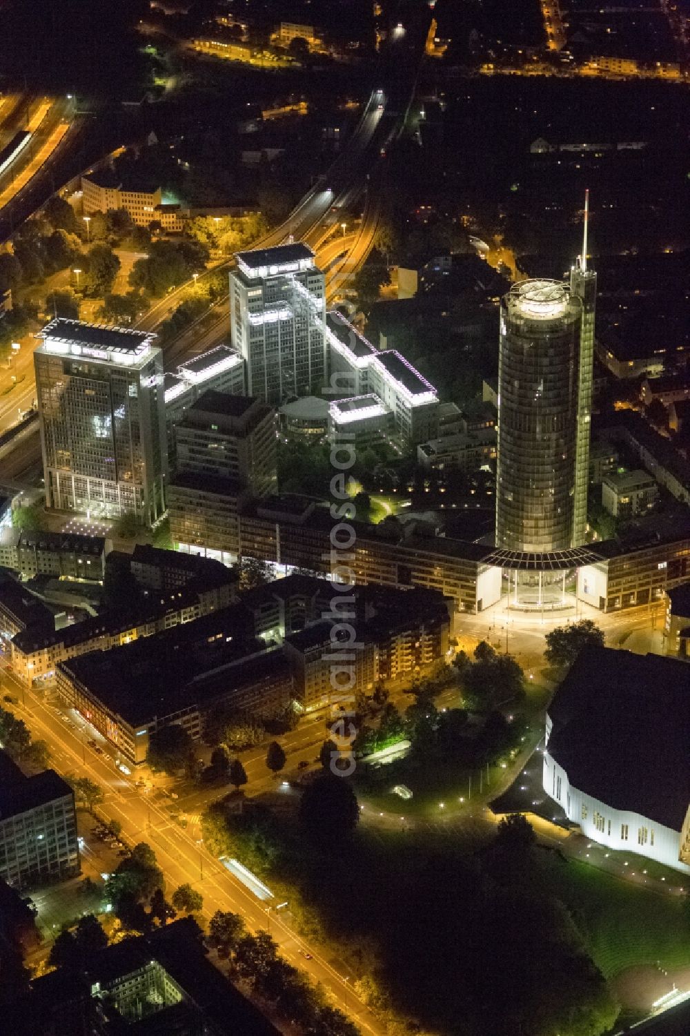 Aerial image at night Essen - View of the RWE headquarters in Essen at night. The RWE Tower is with 120 meters and up to 500 workplaces the headquarter of the energy supplier RWE. The tower is designed ecological and gains energy from natural daylight and solar heat