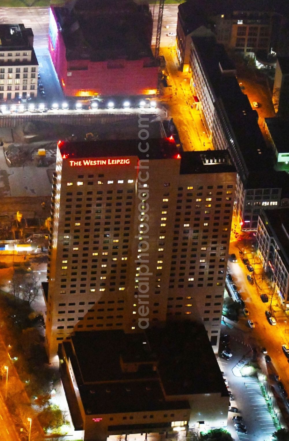 Aerial image at night Leipzig - Night lighting Complex of the hotel building high-rise The Westin Leipzig on Gerberstrasse in Leipzig in the state of Saxony