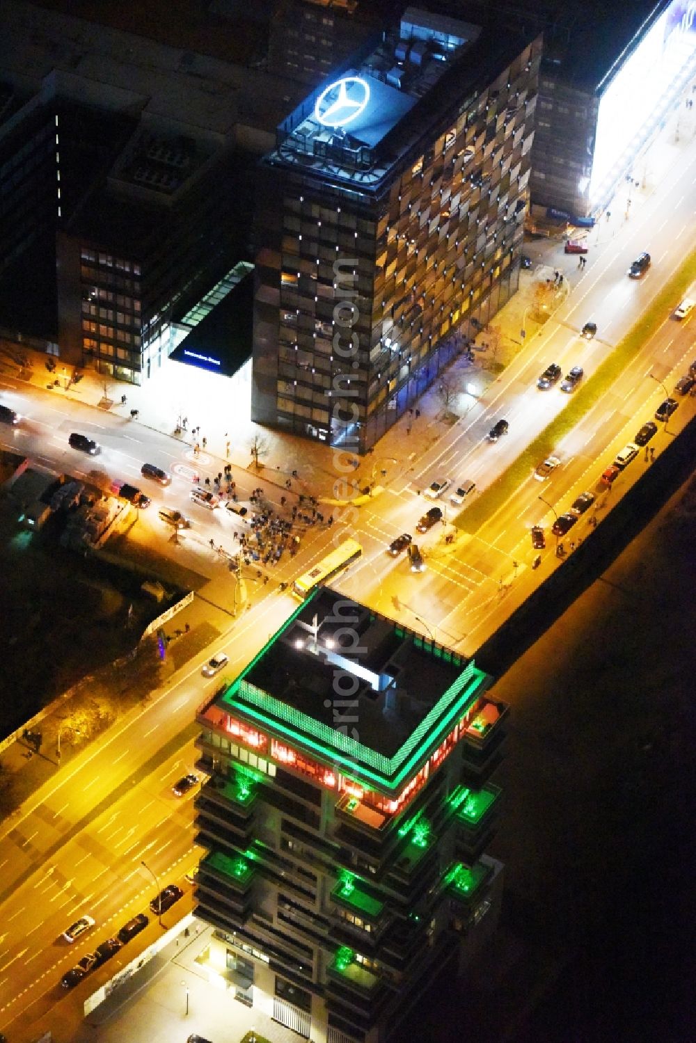 Aerial image at night Berlin - Night lighting project Living Levels at Muhlenstrasse on the banks of the River Spree in Berlin - Friedrichshain. On the grounds of the Berlin Wall border strip at the EastSideGallery, the company Living Bauhaus is building a futuristic high-rise residential