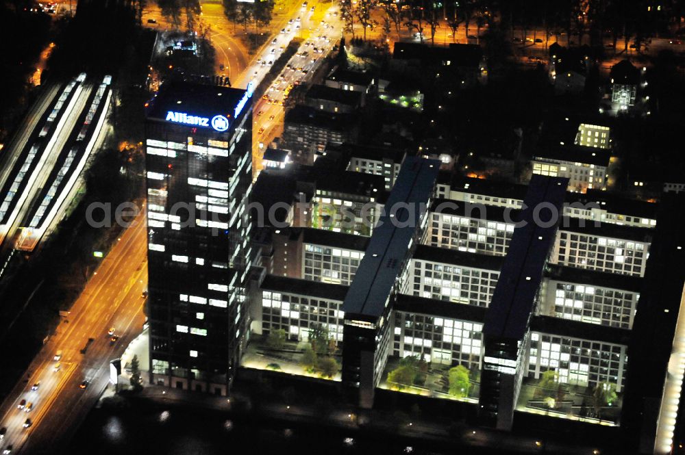 Aerial photograph at night Berlin - Night lighting office buildings and commercial high-rise complex Treptower on street An den Treptowers in the district Treptow in Berlin, Germany