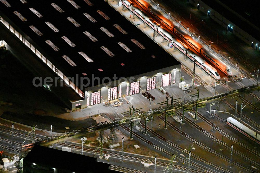 Berlin at night from the bird perspective: Night lighting building of ICE-Werk Berlin Rummelsburg on street Gundelfinger Strasse in the district Rummelsburg in Berlin, Germany