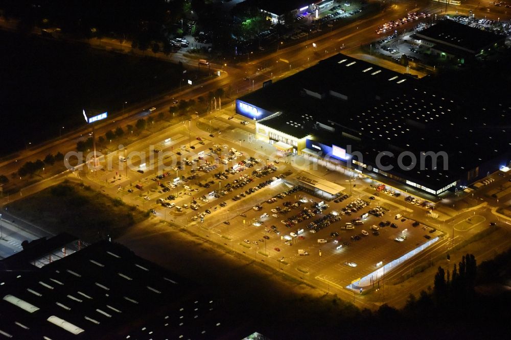 Berlin at night from the bird perspective: Night view IKEA furniture store - Furniture Center at the Landsberger Allee in Berlin - Hohenschonhausen