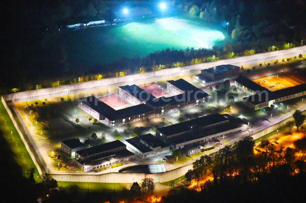 Aerial image at night Wriezen - Night lighting prison grounds and high security fence Prison Justizvollzugsanstalt Nord-Brandenburg Teilanstalt Wriezen on street Schulzendorfer Strasse in the district Luedersdorf in Wriezen in the state Brandenburg, Germany