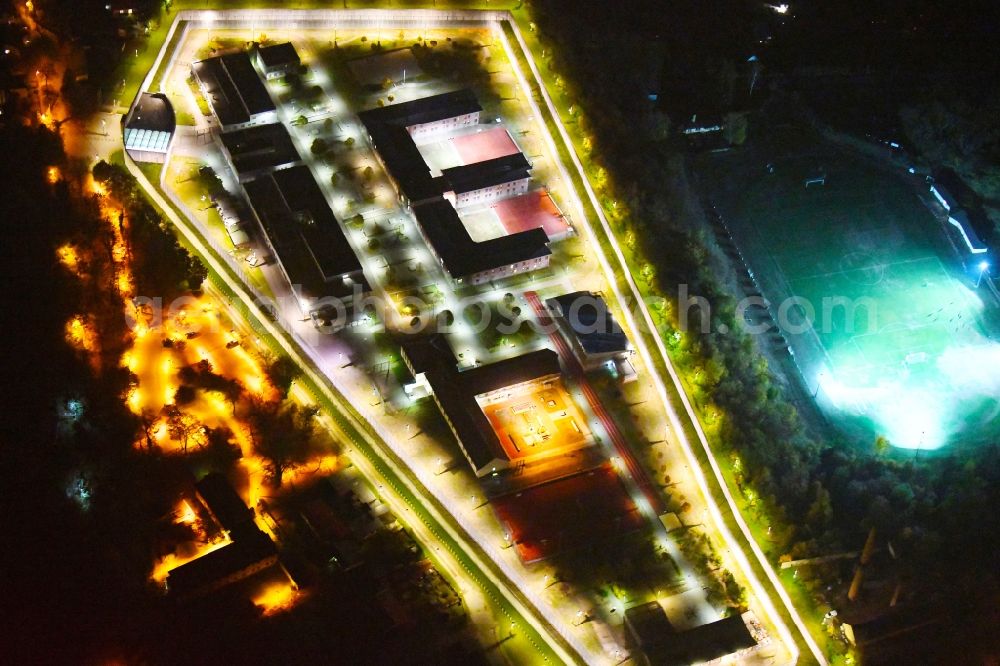 Aerial photograph at night Wriezen - Night lighting prison grounds and high security fence Prison Justizvollzugsanstalt Nord-Brandenburg Teilanstalt Wriezen on street Schulzendorfer Strasse in the district Luedersdorf in Wriezen in the state Brandenburg, Germany