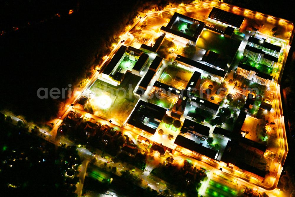 Aerial photograph at night Berlin - Night lighting prison grounds and high security fence Prison Tegel on Seidelstrasse in the district Reinickendorf in Berlin, Germany