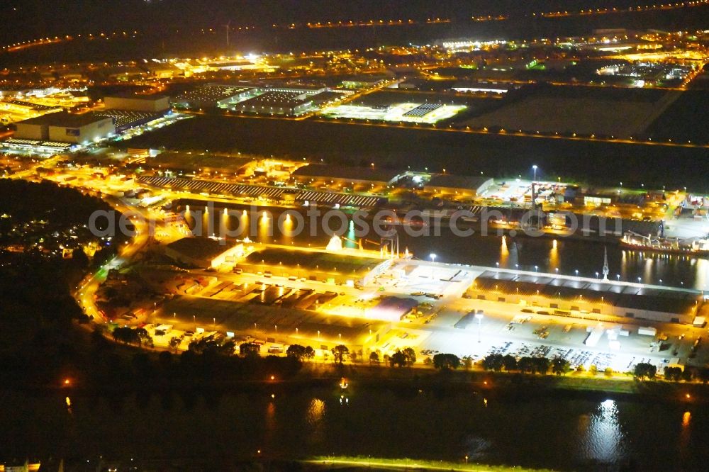 Bremen at night from the bird perspective: Night lighting Quays and boat moorings at the port of the inland port Neustaedter Hafen in Bremen, Germany