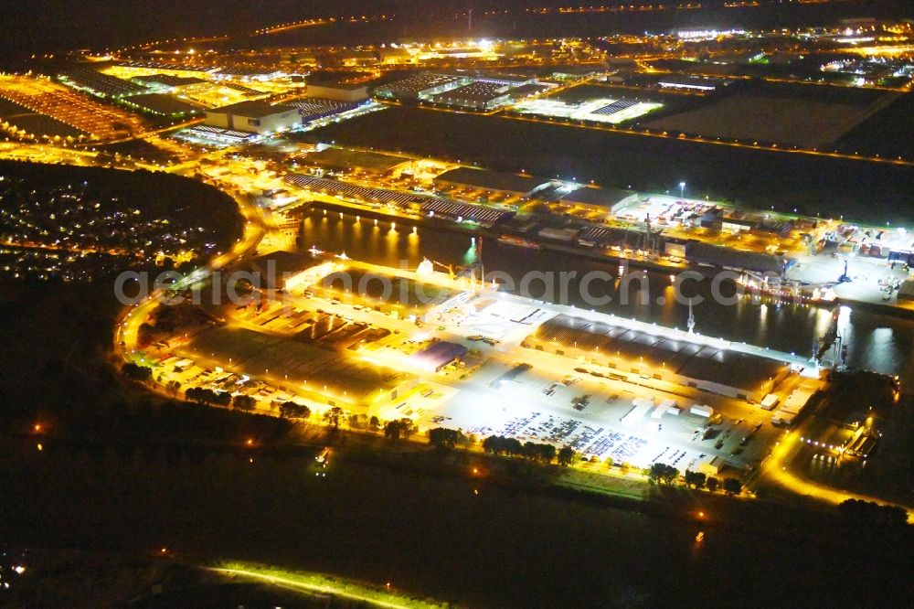 Bremen at night from the bird perspective: Night lighting Quays and boat moorings at the port of the inland port Neustaedter Hafen in Bremen, Germany