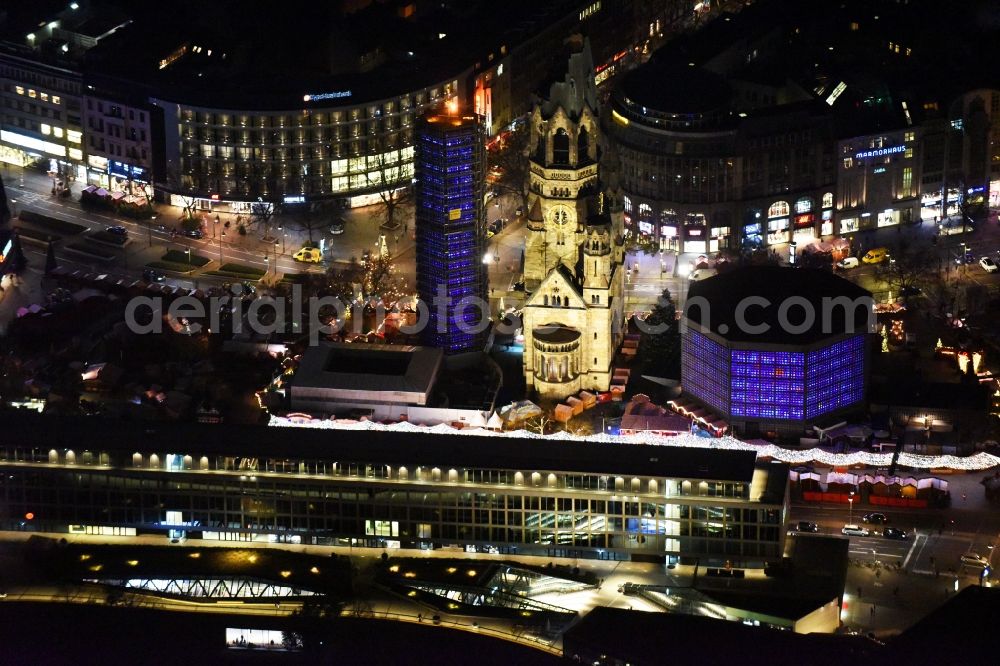 Aerial photograph at night Berlin - Night view of the Protestant Kaiser William Memorial Church, commonly short memorial church with cristmas market on place Breitscheidplatz between the Kurfuerstendamm, the Tauentzienstrasse and the Budapest street in Berlin's Charlottenburg district