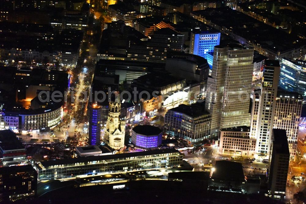 Berlin at night from above - Night view of the Protestant Kaiser William Memorial Church, commonly short memorial church with cristmas market on place Breitscheidplatz between the Kurfuerstendamm, the Tauentzienstrasse and the Budapest street in Berlin's Charlottenburg district