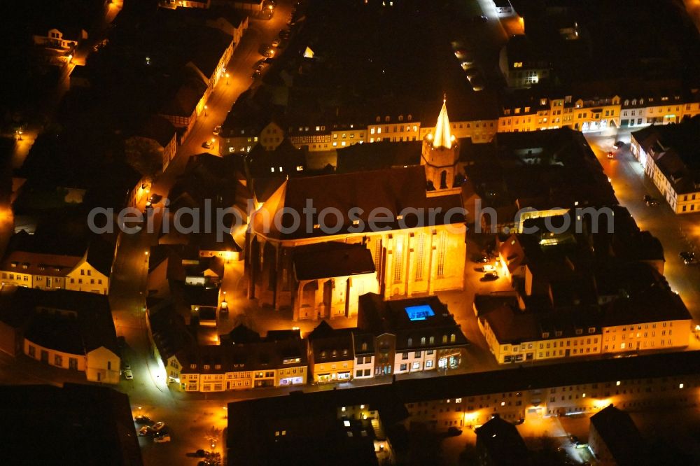 Aerial image at night Beeskow - Night lighting Church building St. Marienkirche in Beeskow in the state Brandenburg, Germany