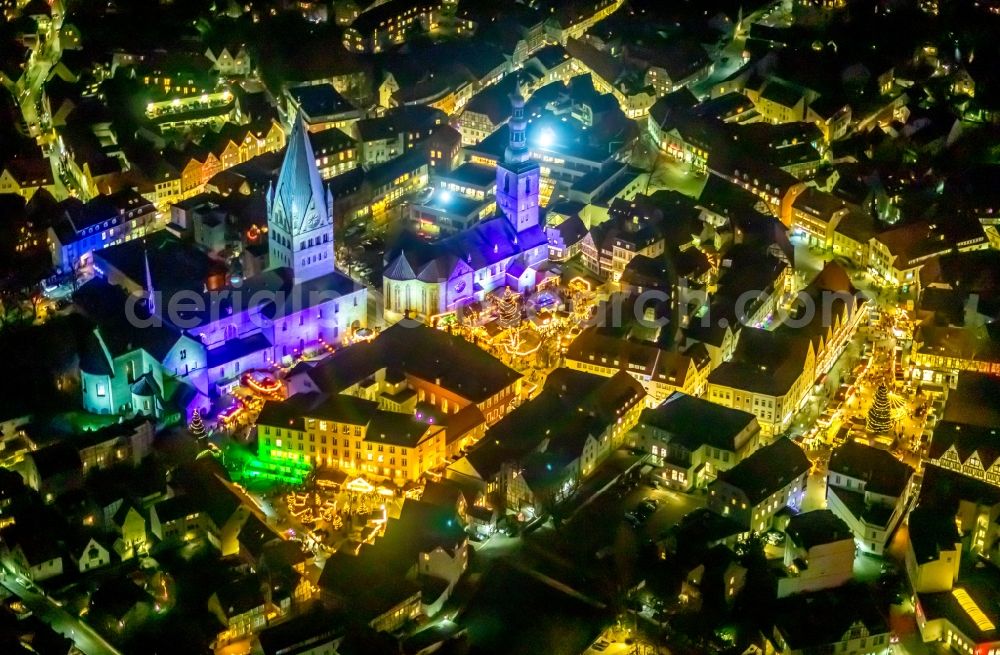 Aerial photograph at night Soest - Night lighting church building in St. Patrokli- Dom and St. Petri (Alde Kerke) Old Town- center of downtown in Soest in the state North Rhine-Westphalia, Germany