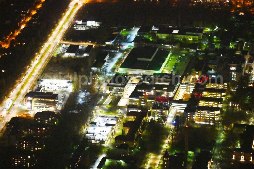 Aerial image at night Berlin - Night lighting Hospital grounds of the Clinic Unfallkrankenhaus Berlin on Warener Strasse in the district Marzahn in Berlin, Germany