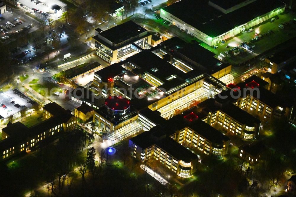 Aerial image at night Berlin - Night lighting Hospital grounds of the Clinic Unfallkrankenhaus Berlin on Warener Strasse in the district Marzahn in Berlin, Germany