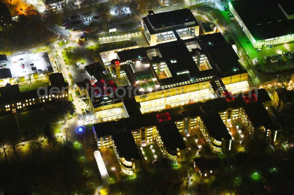 Aerial photograph at night Berlin - Night lighting Hospital grounds of the Clinic Unfallkrankenhaus Berlin on Warener Strasse in the district Marzahn in Berlin, Germany