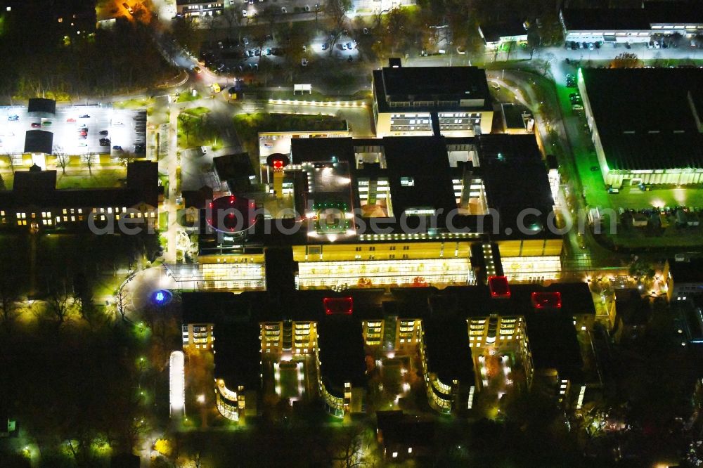 Aerial image at night Berlin - Night lighting Hospital grounds of the Clinic Unfallkrankenhaus Berlin on Warener Strasse in the district Marzahn in Berlin, Germany