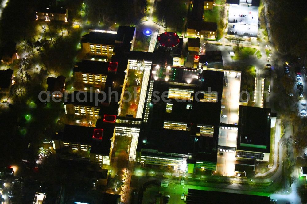 Aerial photograph at night Berlin - Night lighting Hospital grounds of the Clinic Unfallkrankenhaus Berlin on Warener Strasse in the district Marzahn in Berlin, Germany