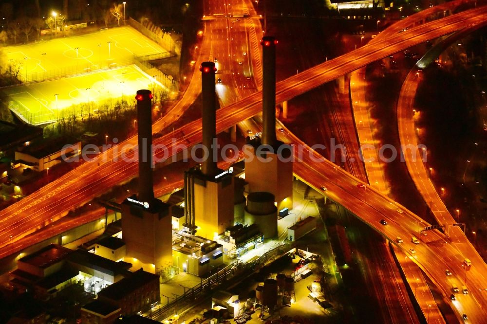 Berlin at night from above - Night lighting power plants and exhaust towers of thermal power station Wilmersdorf on Forckenbeckstrasse in Berlin, Germany