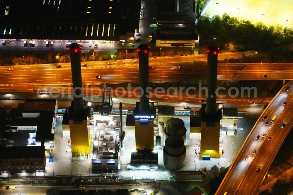 Berlin at night from above - Night lighting power plants and exhaust towers of thermal power station Wilmersdorf on Forckenbeckstrasse in Berlin, Germany