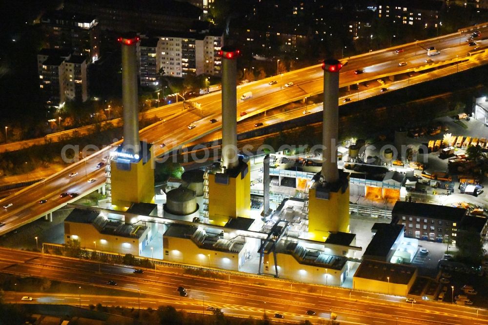Aerial image at night Berlin - Night lighting power plants and exhaust towers of thermal power station Wilmersdorf on Forckenbeckstrasse in Berlin, Germany