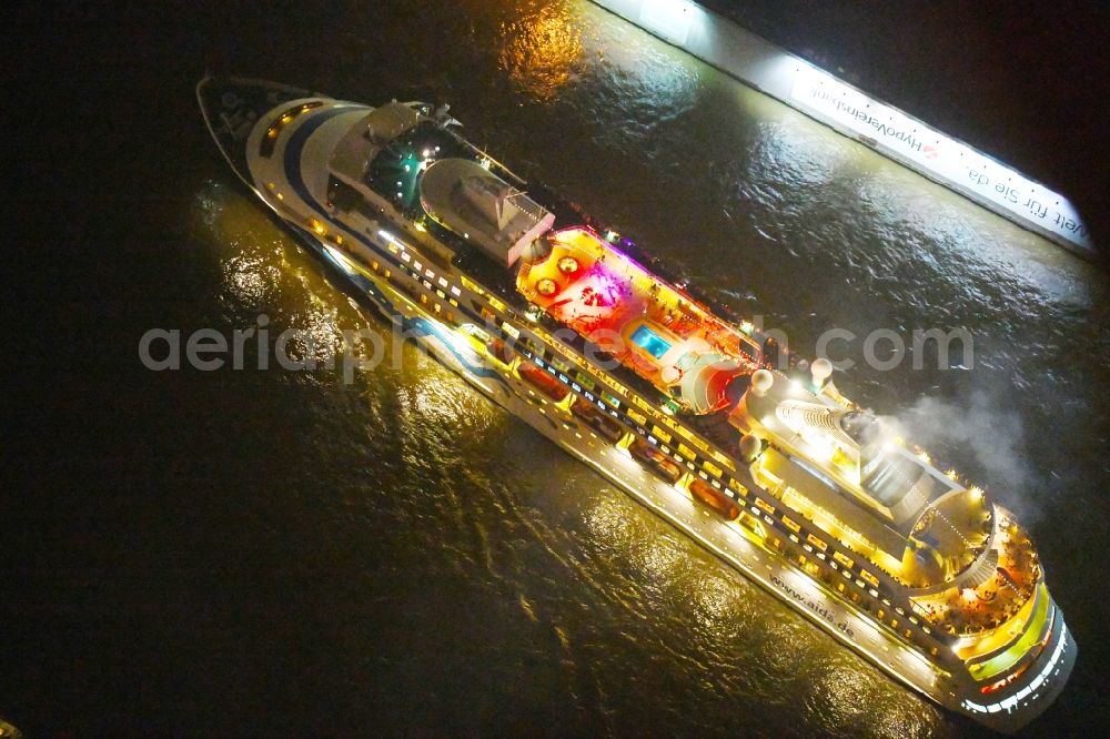 Aerial photograph at night Hamburg - Night lighting Cruise and passenger ship AIDAcara on elbe river in Hamburg, Germany