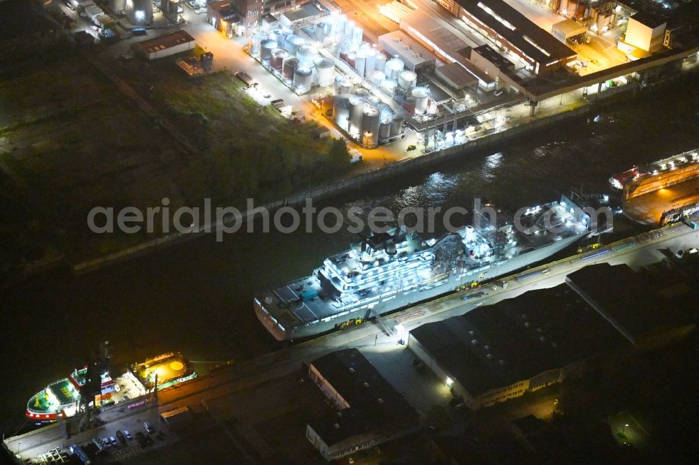 Hamburg at night from the bird perspective: Night lighting Ship of the German Navy Berlin A 1411 in the port of Hamburg, Germany