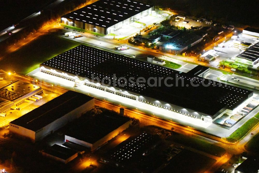 Radeburg at night from above - Night lighting warehouses and forwarding building Lidl Zentrallager on Guerickestrasse in Radeburg in the state Saxony, Germany