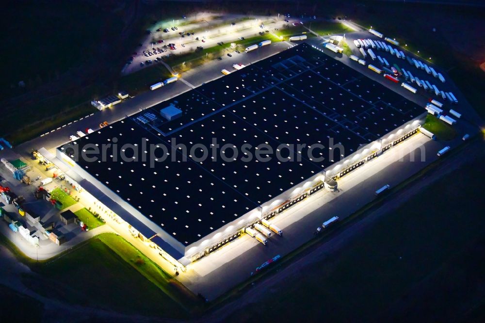 Aerial image at night Berlin - Night lighting warehouses and forwarding building Netto Grosslager in the district Buch in Berlin, Germany