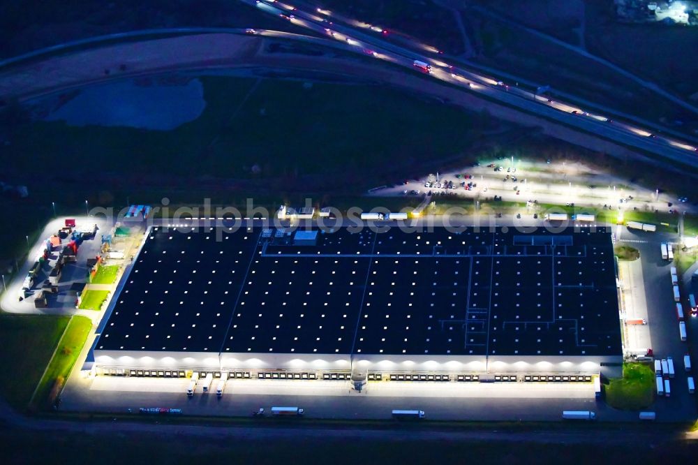 Berlin at night from the bird perspective: Night lighting warehouses and forwarding building Netto Grosslager in the district Buch in Berlin, Germany