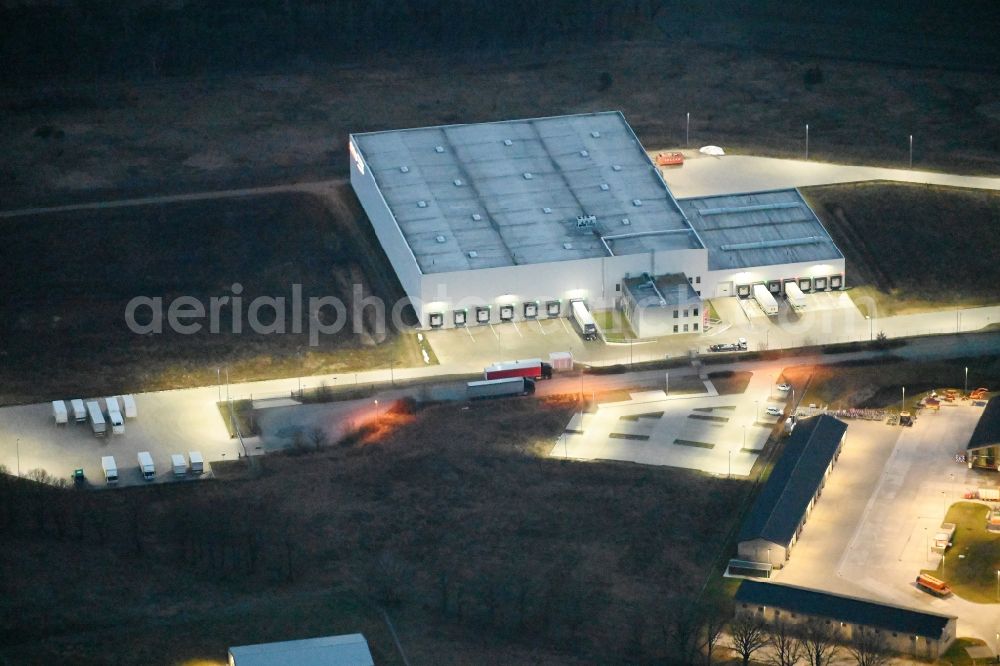 Aerial photograph at night Fahrbinde - Night lighting warehouses and forwarding building of Raben Trans European Germany in Fahrbinde in the state Mecklenburg - Western Pomerania, Germany