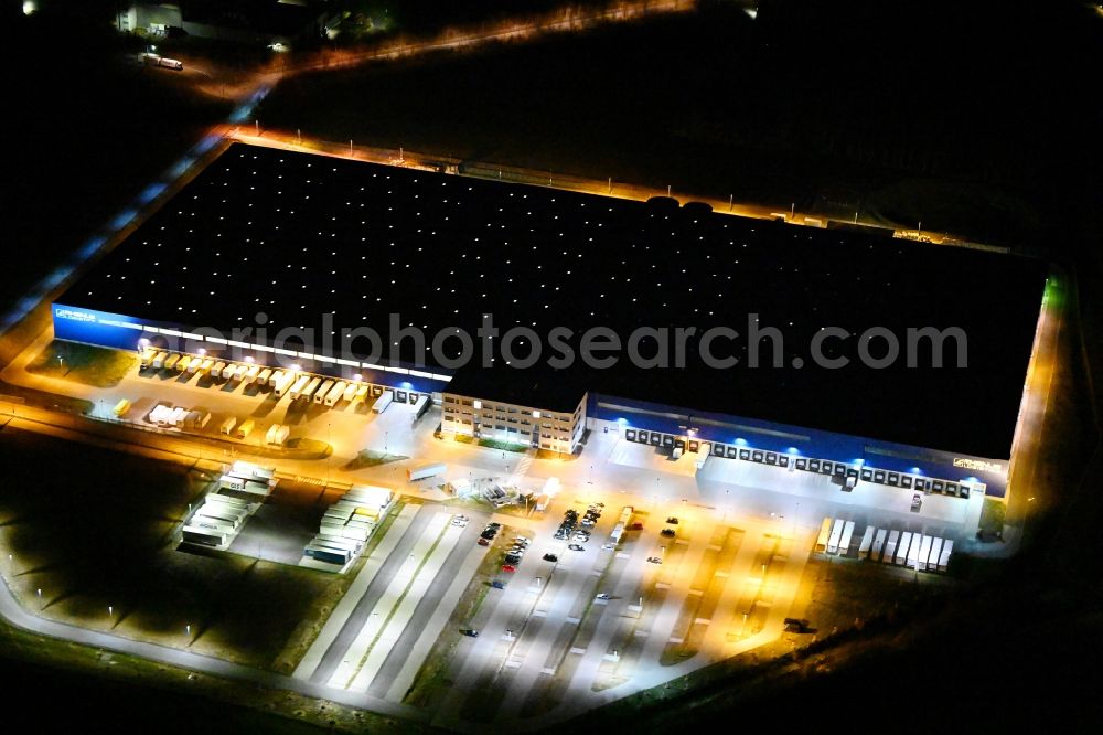 Hörselgau at night from the bird perspective: Night lighting warehouses and forwarding building of Rhenus SE & Co. KG in Hoerselgau in the state Thuringia, Germany