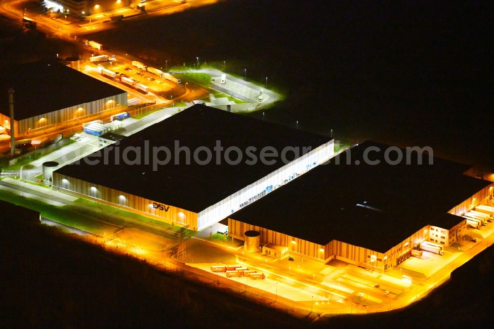 Aerial photograph at night Leipzig - Night lighting Warehouses and forwarding building of Schnellecke Modul- and Lieferantenzentrum GmbH Am Exer in the district Wahren in Leipzig in the state Saxony, Germany