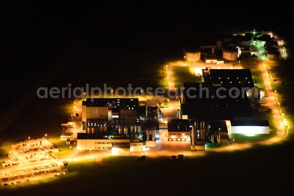 Klatzow at night from above - Night lighting buildings and production halls on the food manufacturer's premises DMK Deutsches Milchkontor GmbH in Klatzow in the state Mecklenburg - Western Pomerania, Germany