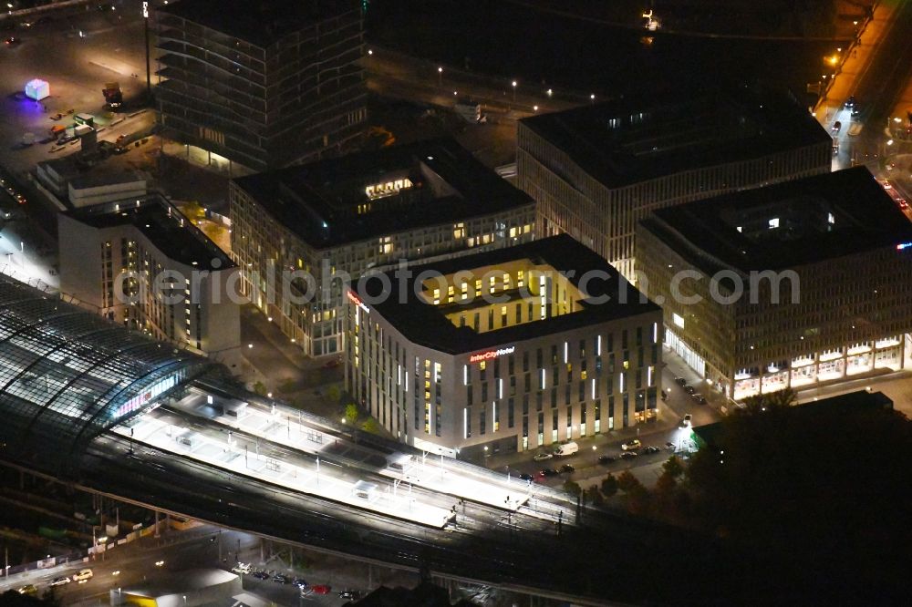 Aerial image at night Berlin - Night lighting Lehrter Stadtquartier quarter in the Moabit part of Berlin in Germany. The quarter consists of 5 blocks which form a complex of office buildings and hotels