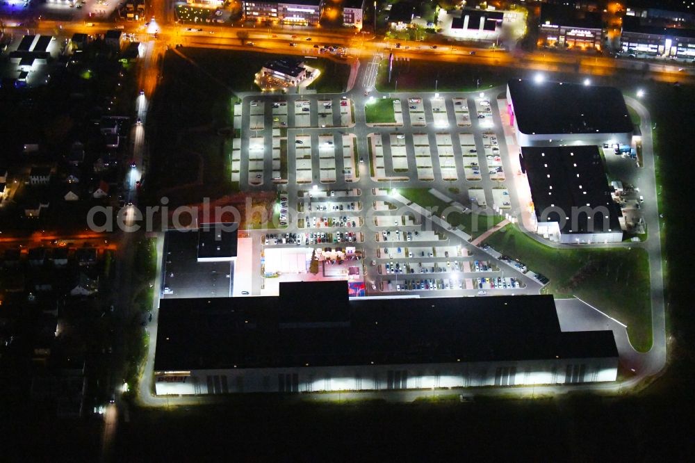 Aerial photograph at night Berlin - Night lighting site for the new building home-center of the Porta-Group at Pilgramer street in the district Mahlsdorf in Berlin