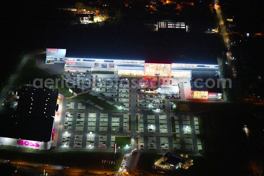 Aerial image at night Berlin - Night lighting site for the new building home-center of the Porta-Group at Pilgramer street in the district Mahlsdorf in Berlin