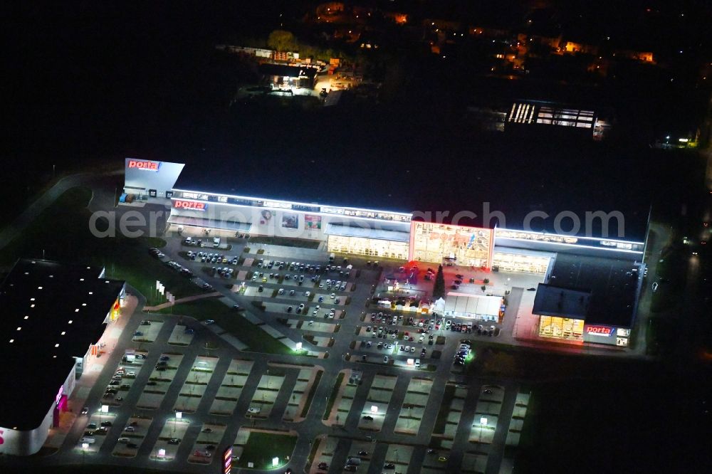 Berlin at night from the bird perspective: Night lighting site for the new building home-center of the Porta-Group at Pilgramer street in the district Mahlsdorf in Berlin