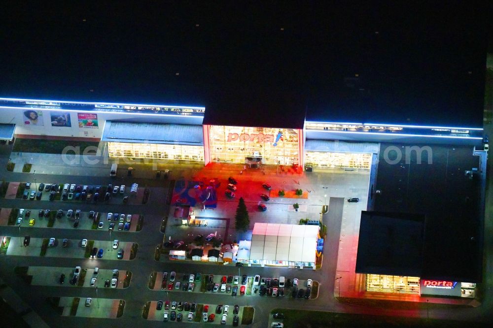 Aerial photograph at night Berlin - Night lighting site for the new building home-center of the Porta-Group at Pilgramer street in the district Mahlsdorf in Berlin