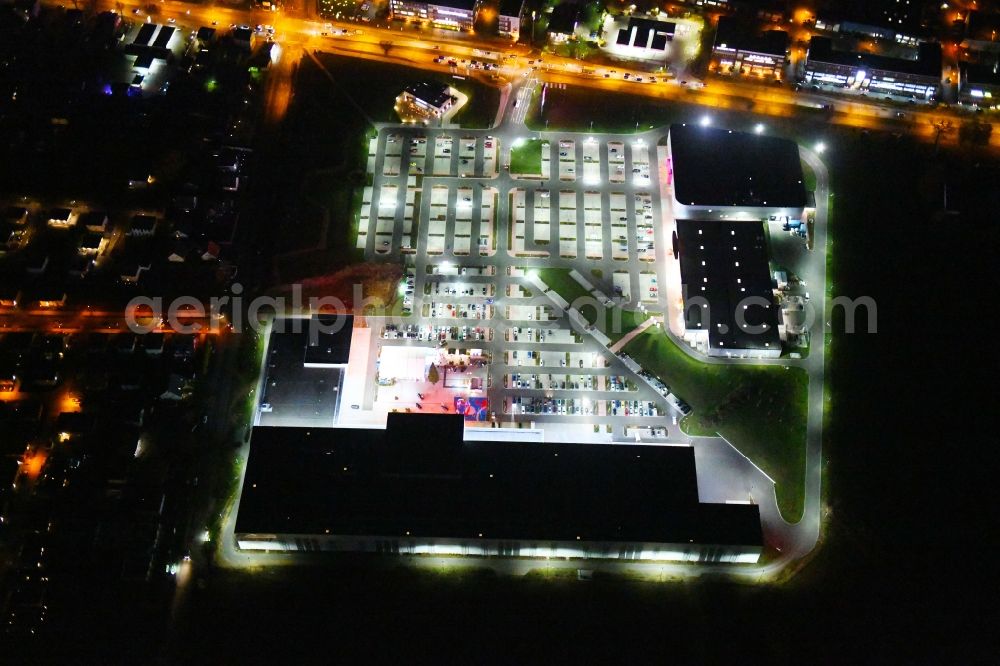 Aerial image at night Berlin - Night lighting site for the new building home-center of the Porta-Group at Pilgramer street in the district Mahlsdorf in Berlin