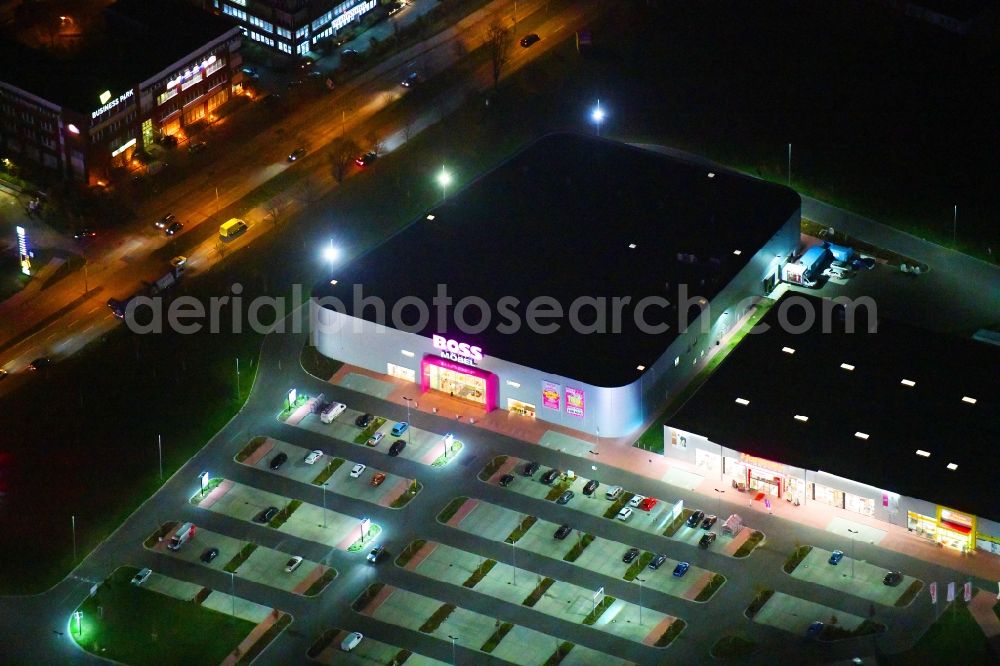 Aerial image at night Berlin - Night lighting site for the new building home-center of the Porta-Group at Pilgramer street in the district Mahlsdorf in Berlin