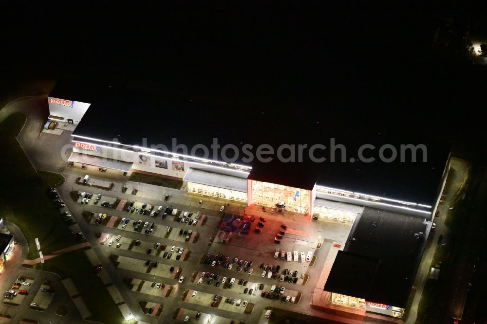 Aerial photograph at night Berlin - Night lighting site for the new building home-center of the Porta-Group at Pilgramer street in the district Mahlsdorf in Berlin