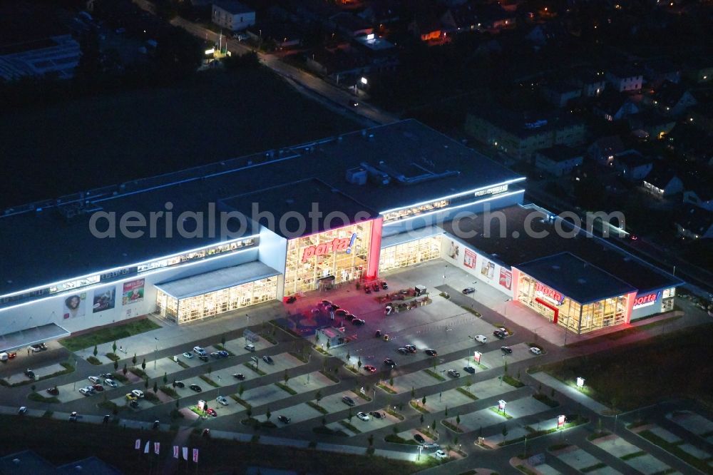 Aerial image at night Berlin - Night lighting site for the new building home-center of the Porta-Group at Pilgramer street in the district Mahlsdorf in Berlin