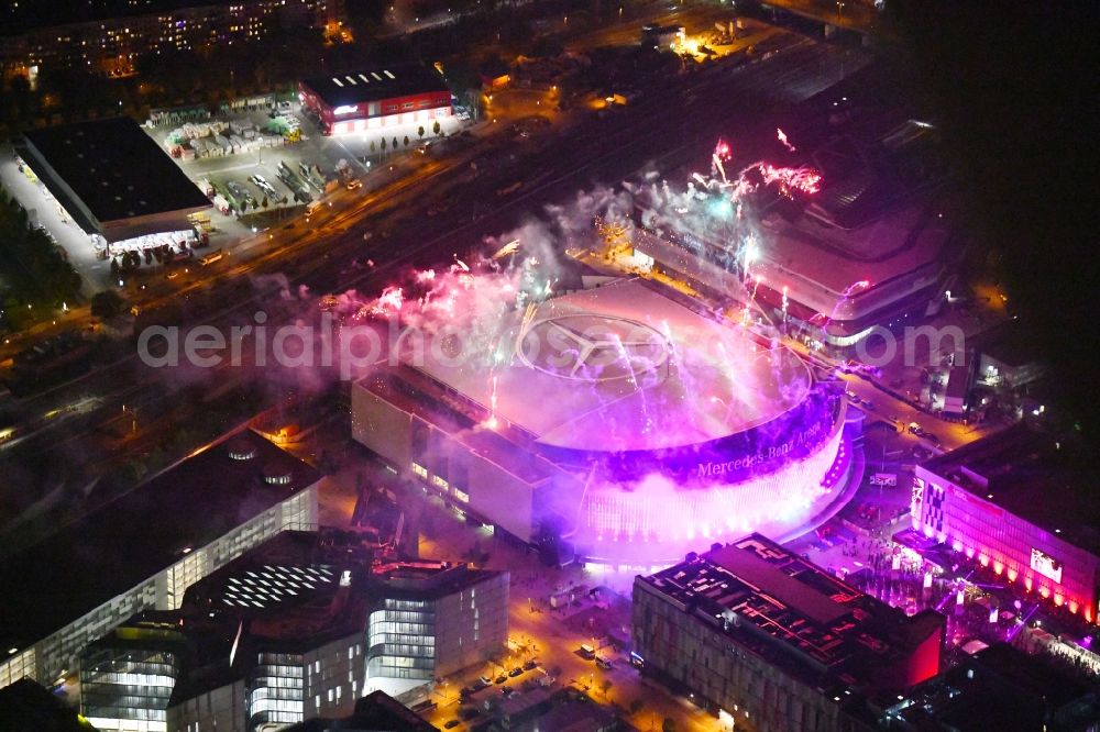 Berlin at night from the bird perspective: Night lighting Arena Mercedes-Benz-Arena on Friedrichshain part of Berlin. The former O2 World - now Mercedes-Benz-Arena - is located in the Anschutz Areal, a business and office space on the riverbank