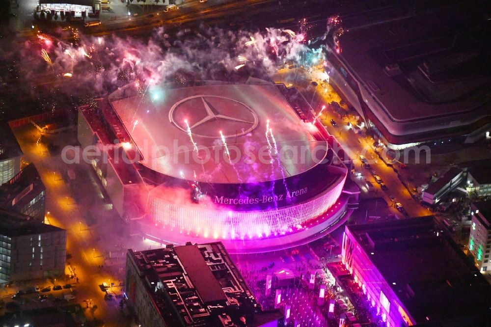 Aerial image at night Berlin - Night lighting Arena Mercedes-Benz-Arena on Friedrichshain part of Berlin. The former O2 World - now Mercedes-Benz-Arena - is located in the Anschutz Areal, a business and office space on the riverbank