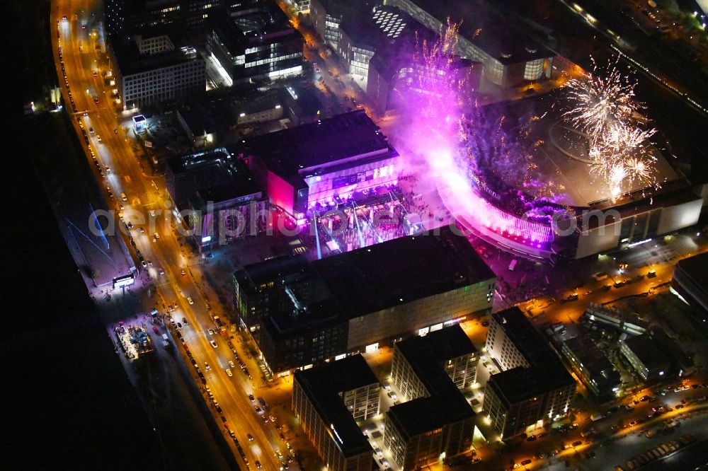 Aerial image at night Berlin - Night lighting Arena Mercedes-Benz-Arena on Friedrichshain part of Berlin. The former O2 World - now Mercedes-Benz-Arena - is located in the Anschutz Areal, a business and office space on the riverbank